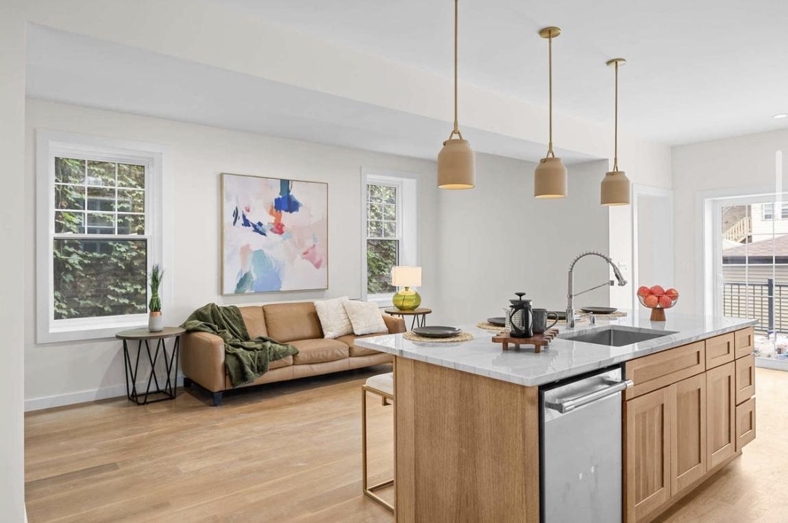 Open-concept kitchen with pendant and recessed lighting by Peak Property Electric