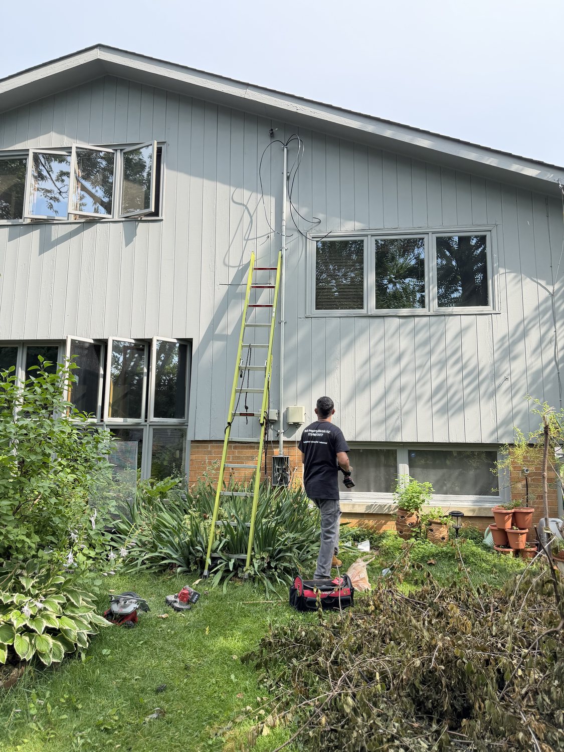 Peak Property Electric upgrading an exterior service riser and mast